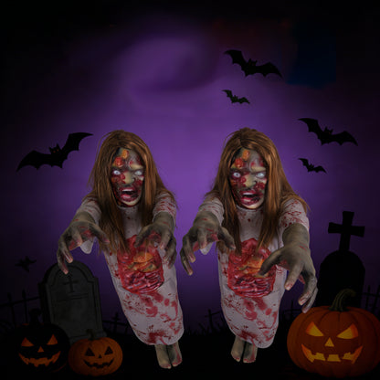 Blonde female corpse Halloween prop posed beside an RIP tombstone