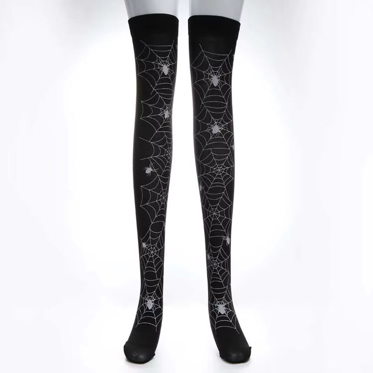 Model wearing black spider web thigh-high stockings on a clean background