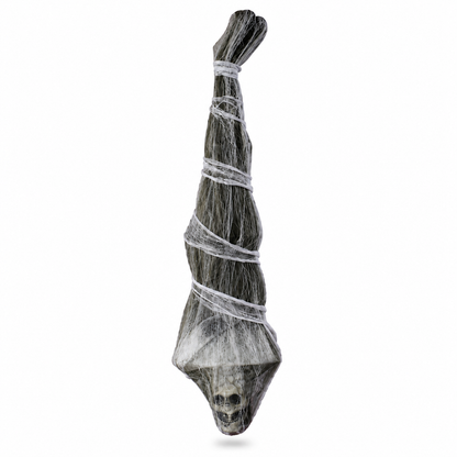 Side view of upside-down mummy prop with skull beneath cobweb gauze