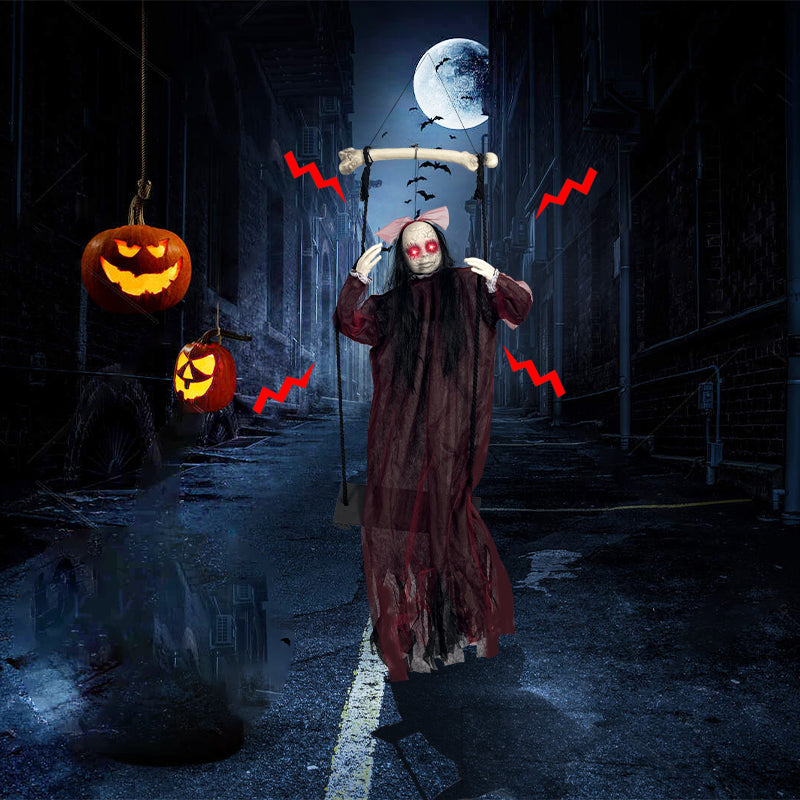 Red ghost swing Halloween decoration displayed with glowing pumpkins at night