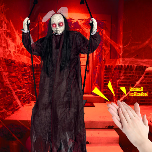 Sound-activated red ghost on a swing with glowing red eyes