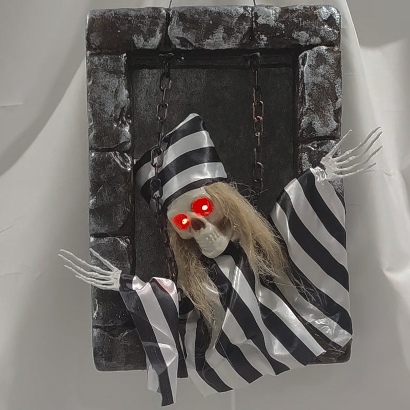 Striped prisoner animated tombstone figure with glowing red eyes