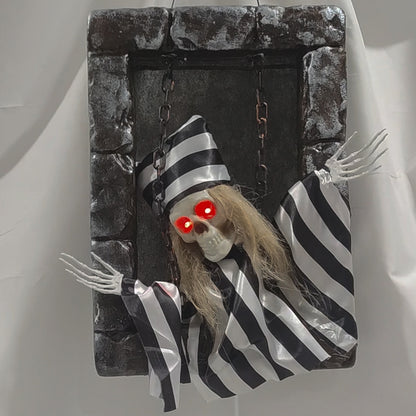Striped prisoner animated tombstone figure with glowing red eyes