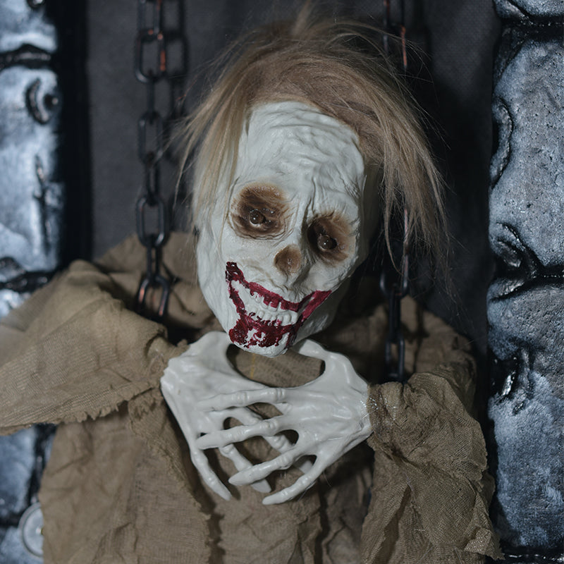 Close-up of the yellow-robed skeleton figure inside the stone tombstone frame
